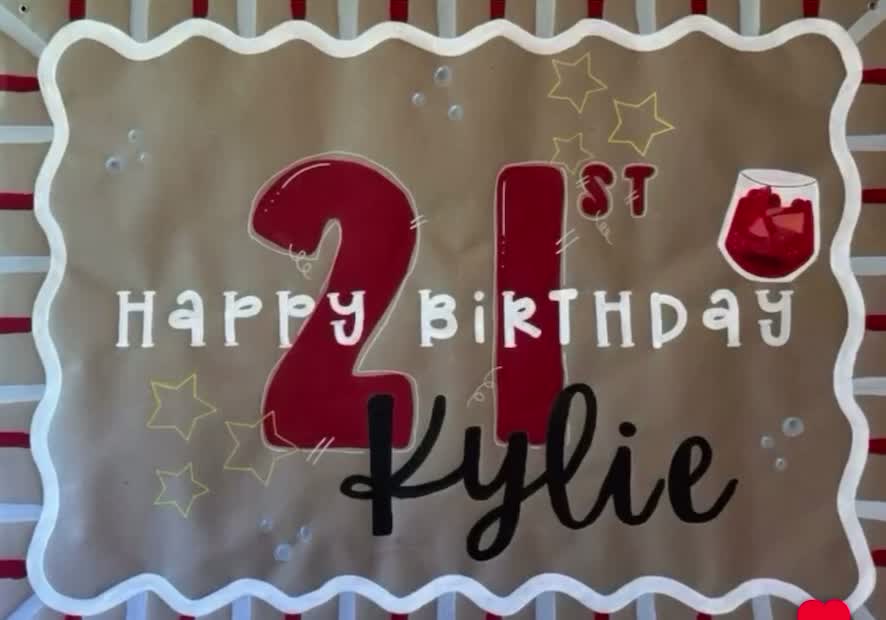 Custom hand-painted 21st birthday banner for Kylie, with burgundy lettering and a white wavy border
